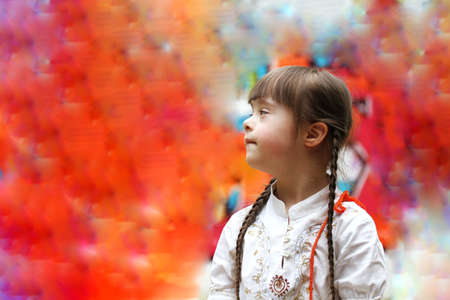 Portrait of little girl smiling on background of the colorful wallの写真素材