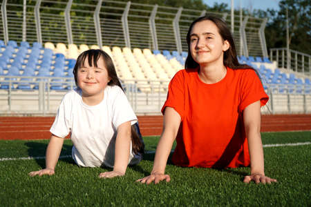 Little girl on the stadium with a coachの写真素材