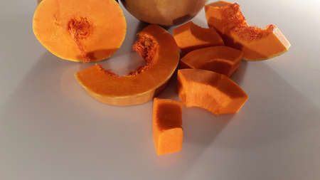 Sliced ripe pumpkin. Pieces of pumpkin. Vegetable backgroundの写真素材