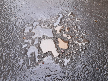 Wet asphalt. Oil stains and drops on the pavement. creative backgroundの写真素材
