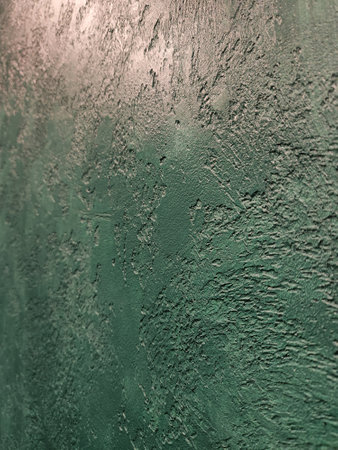 Green decorative plaster. Decorative finishing of walls and surfaces with plaster. vintage background in green colorの写真素材