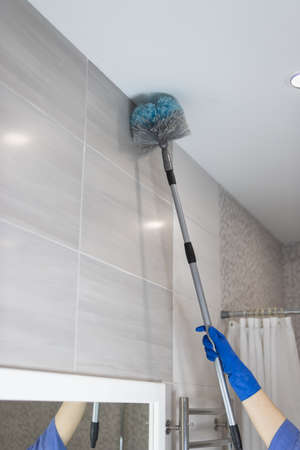 cleaning the bathroom girls hands in blue gloves cleaning conceptの写真素材