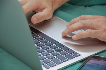 man typing on laptop hands on keyboard closeup freelancing concept