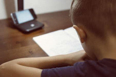 boy doing homework in children roomの写真素材
