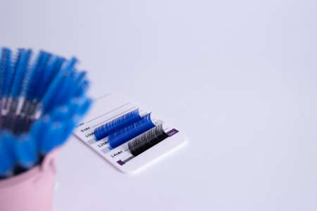 Artificial eyelashes in black and blue on a white backgroundの写真素材