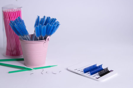 Artificial eyelashes in black and blue on a white background