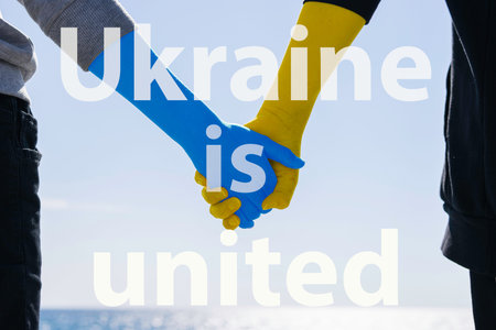 Ukraine love concept. hold hands painted in colors yellow and blue.の写真素材