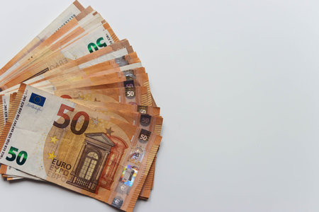 close-up on a white background spread out like a fan a lot of money euro 50 bills.with the right...