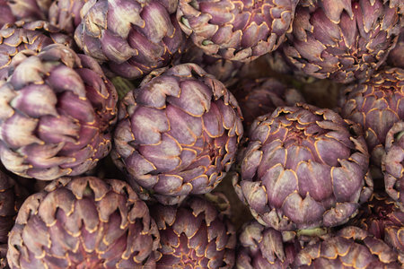 a lot of artichokes close-up. Artichokes are sold on a showcase, healthy food.の写真素材