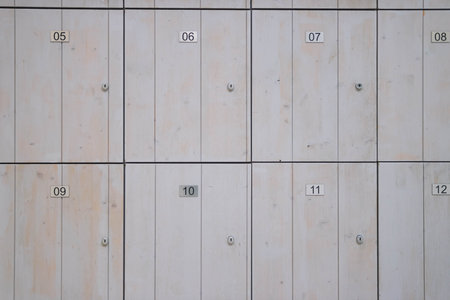 brown wooden lockers for storing things in the store. Lockers with numbers and a lock close-up