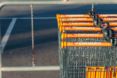 Many rows of trolleys outside the store with a close-up of the parking ,Spain, Torrevieja shop Consum , August 10, 2023のeditorial素材