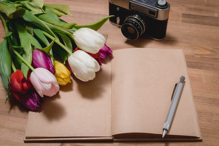 tulips notepad camera wooden table
