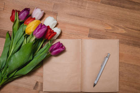 tulips notebook wooden tableの写真素材