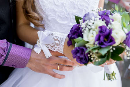 groom with the bride, the bride's bouquet, the bride is holding a bouquet, the bridegroom embraces the bride. close-upの写真素材