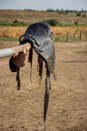 Horse saddle on rural fence. horse saddle close upの写真素材