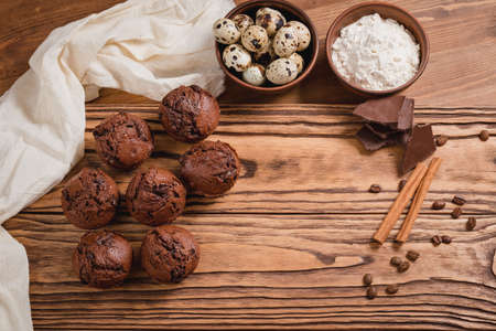 chocolate mafin on a wooden background. quail eggs cinnamon and chocolateの写真素材