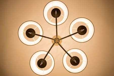 A glowing chandelier with not transparent bottles close-up hanging on the ceiling.