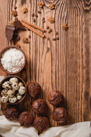chocolate mafin on a wooden background. quail eggs cinnamon and chocolateの写真素材