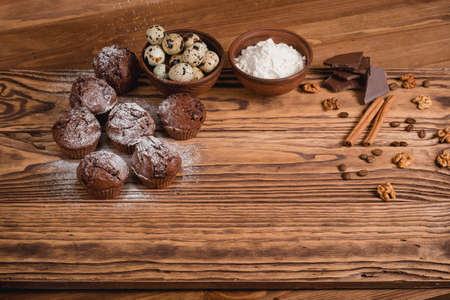 chocolate mafin on a wooden background. quail eggs cinnamon and chocolateの写真素材