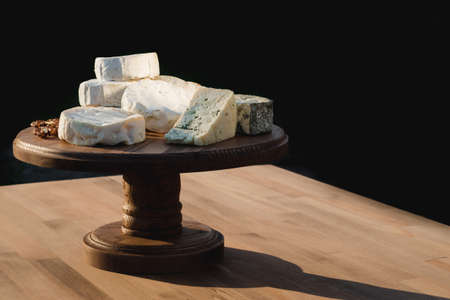 cheese plate. different cheeses on a wooden plate. Close upの写真素材