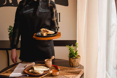 Mexican burrito with chicken, vegetables, pepper and beans. Burrithos quesadilla food in hand. Close upの写真素材