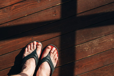 mens feet on wooden floor. mens legs stand on the wooden floor.