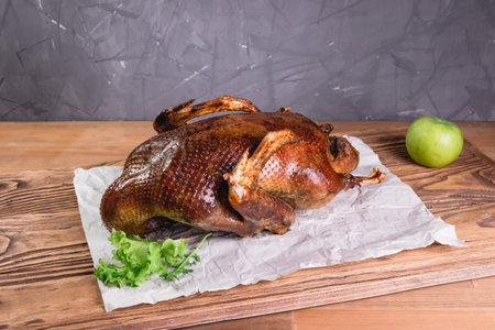 Roasted duck with apples. baked whole duck close-up on a platter on the table. Horizontal view from aboveの写真素材