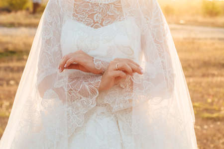 beautiful bride covered herself with veil. Close up. copyspaceの写真素材
