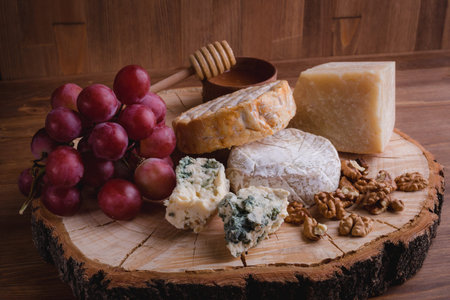 cheese plate on a wooden table. rustic. Close up.