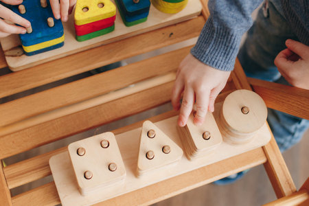 child holds educational toys. Close up. Top view.