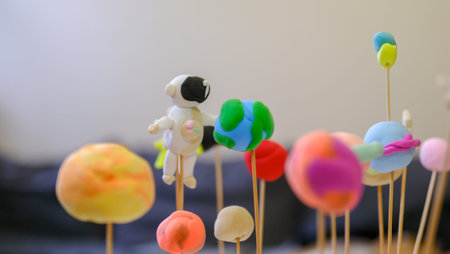 Solar system model toy planets made by kid from colorful molding clay on beige background with blank space for text. DIY activity for children concept.の写真素材