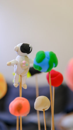 Solar system model toy planets made by kid from colorful molding clay on beige background with blank space for text. DIY activity for children concept.の写真素材