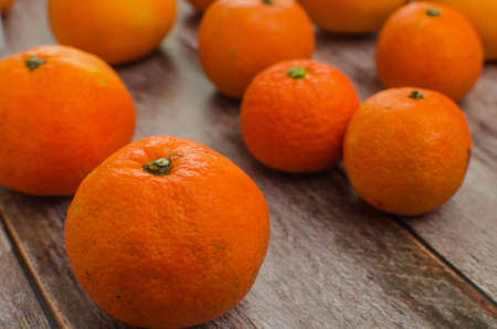 tangerines, peeled tangerine and tangerine slices on a white wooden table. copy spaceの写真素材