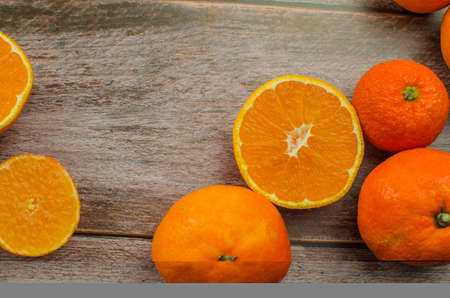 tangerines, peeled tangerine and tangerine slices on a white wooden table. copy spaceの写真素材