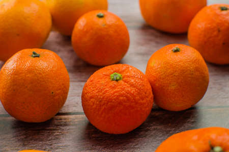 tangerines, peeled tangerine and tangerine slices on a white wooden tableの写真素材