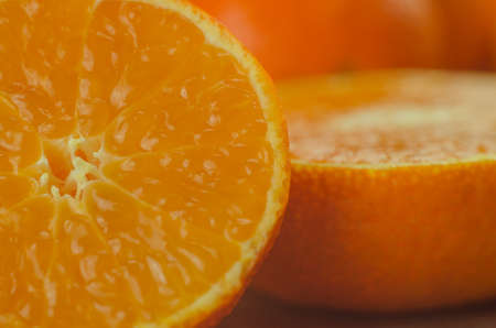 tangerines, peeled tangerine and tangerine slices on a white wooden tableの写真素材