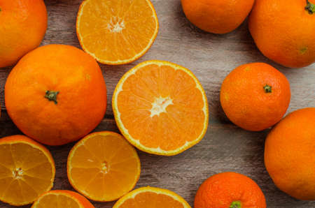 tangerines, peeled tangerine and tangerine slices on a white wooden table. copy spaceの写真素材