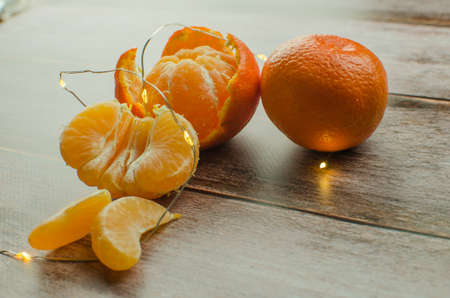 tangerines, peeled tangerine and tangerine slices on a white wooden table. copy spaceの写真素材