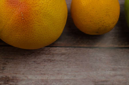 Citrus fruits orange, lemon, grapefruit, mandarin, lime on a wooden backgroundの写真素材