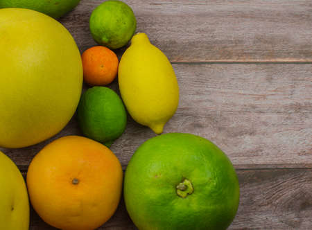 Citrus fruits orange, lemon, grapefruit, mandarin, lime on a wooden backgroundの写真素材
