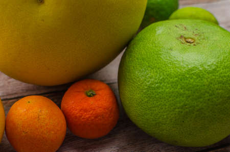 Citrus fruits orange, lemon, grapefruit, mandarin, lime on a wooden backgroundの写真素材