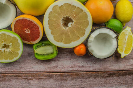 Citrus fruits orange, lemon, grapefruit, mandarin, lime on a wooden backgroundの写真素材