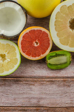 Citrus fruits orange, lemon, grapefruit, mandarin, lime on a wooden backgroundの写真素材