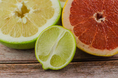 Citrus fruits orange, lemon, grapefruit, mandarin, lime on a wooden backgroundの写真素材