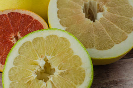 Citrus fruits orange, lemon, grapefruit, mandarin, lime on a wooden backgroundの写真素材
