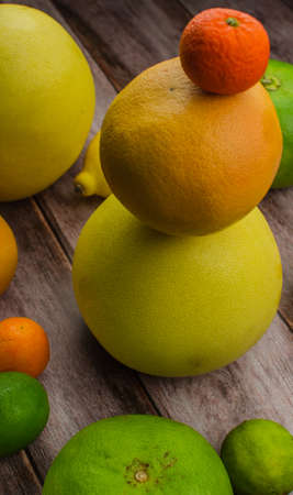 Citrus fruits orange, lemon, grapefruit, mandarin, lime on a wooden backgroundの写真素材