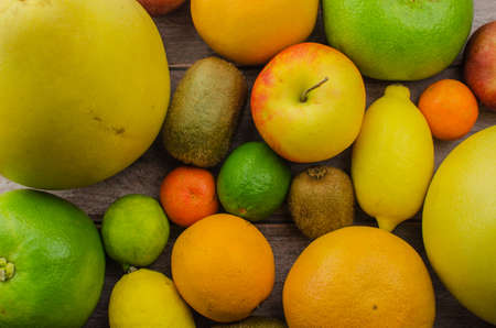 Citrus fruits orange, lemon, grapefruit, mandarin, lime on a wooden backgroundの写真素材