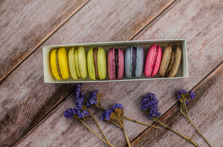 French macaroon cake. Macaroons in box with dried flowers