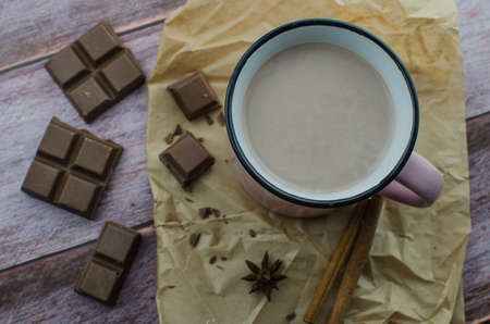 Cocoa drink with spices, zephyr and macaroons on wooden backgroundの写真素材