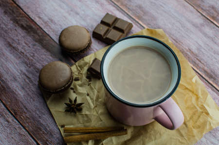 Cocoa drink with spices, zephyr and macaroons on wooden backgroundの写真素材